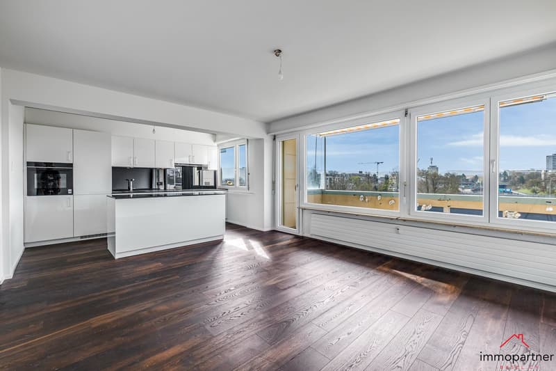 modern kitchen with white cabinets, wooden floor, large windows, island countertop, modern appliances
