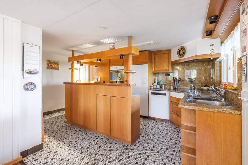 modern design kitchen, wooden cabinets, granite countertops, stainless steel appliances, island with bar stools