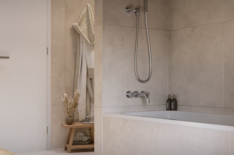 Sleek bathtub, stainless steel showerhead, white tiles, wooden shelving, folded towels, decorative vase, towel rack, minimalistic design.
