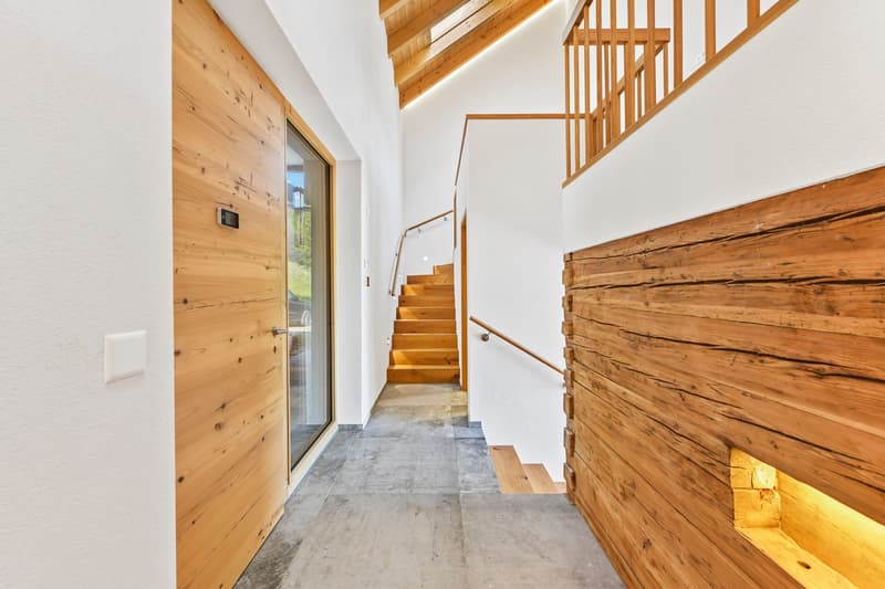 wooden walls, concrete floor, wooden stairs, glass door, wooden handrail