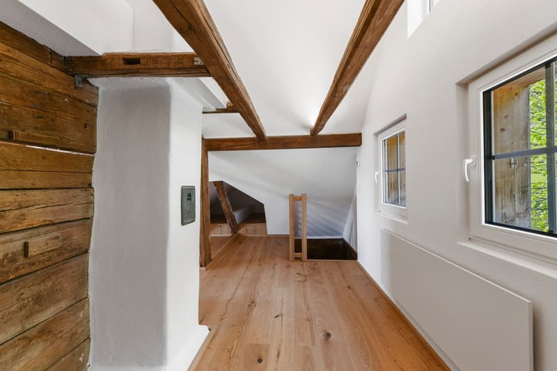 wooden beams, wooden floor, white walls, windows, wooden wall paneling