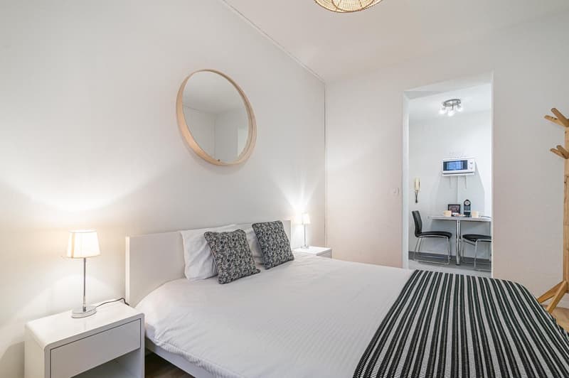 white walls, bed, lamps, table, microwave, dining table, microwave, chair, mirror, desk