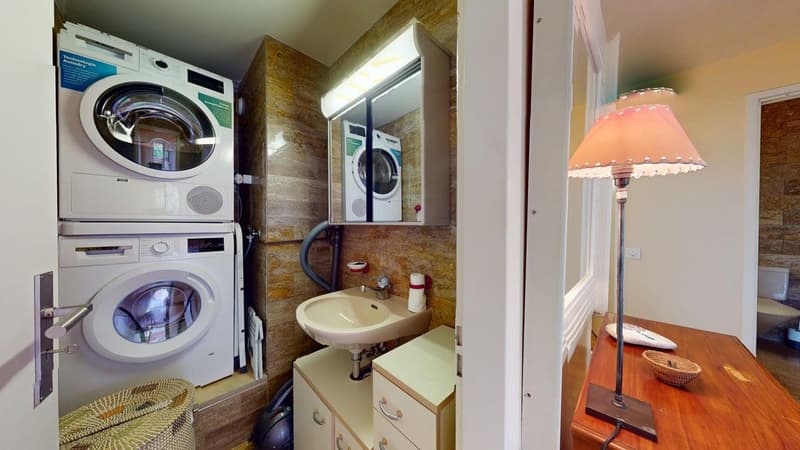 Laundry area with washing machine and dryer, sink, and cabinets