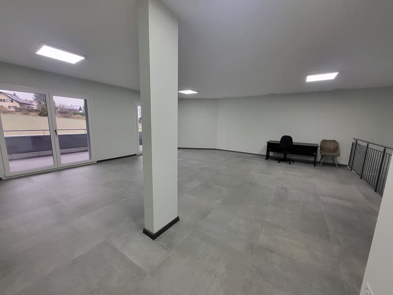 empty room, gray tiled floor, glass sliding door, two chairs, desk, white walls, built-in lights