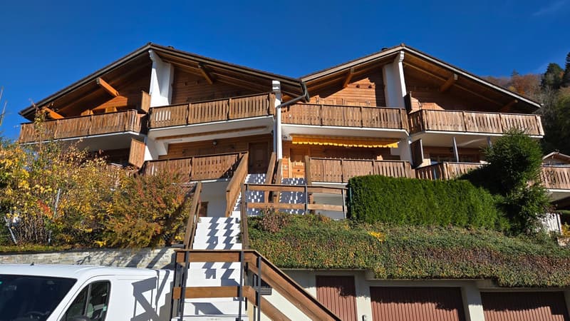 wooden exterior, two floors, balcony, garage