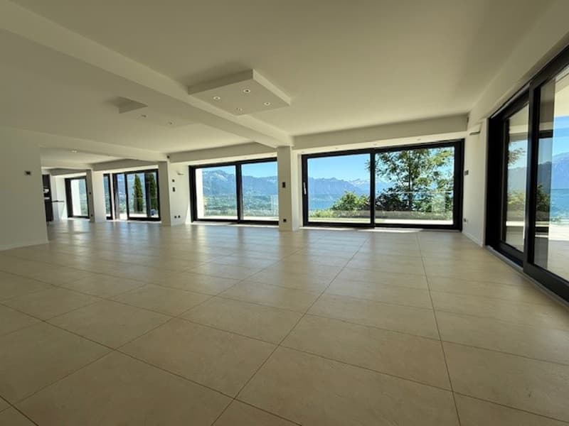 large room, tiled floor, large windows, view of mountains and sea