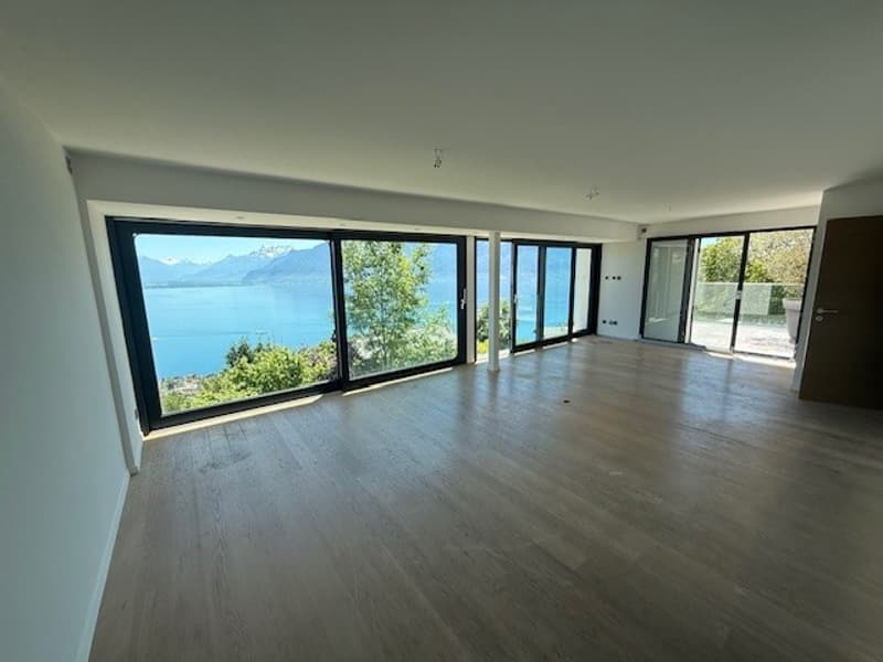 large windows, wooden floor, white walls, view of the lake and mountains