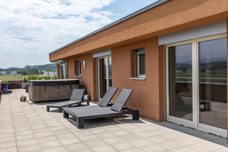 Terrace with two loungers, hot tub, tiled floor, glass door, glass windows
