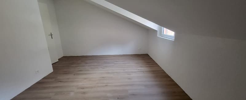 empty room, wooden floor, white walls, small window, door