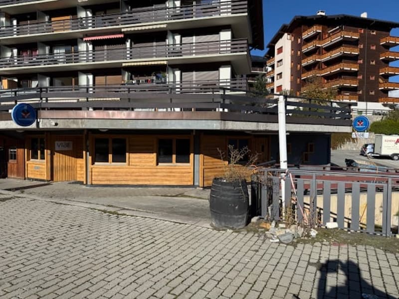 3 story building, balconies, wooden facade, brick pavement
