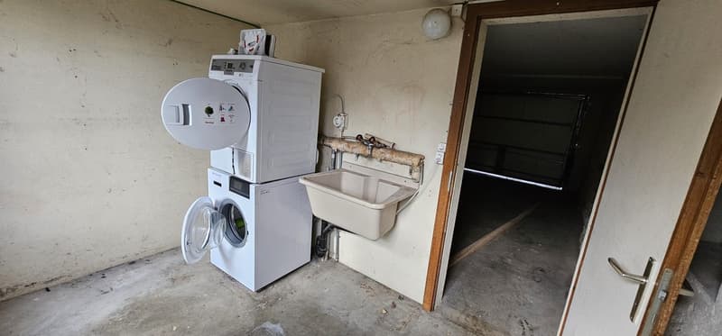 Laundry room with washing machine, dryer and sink.