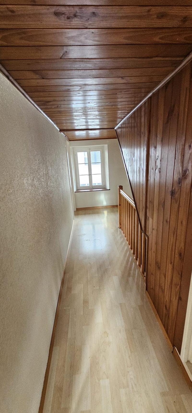 Hardwood floor, wooden ceiling, window with shutters, wooden staircase