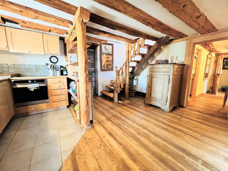 kitchen with wooden beams, wooden floor, wooden cabinets, oven, sink, wooden staircase