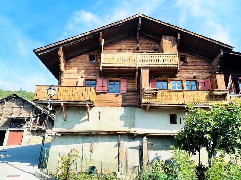 3 story wooden house, red shutters, balconies, street lamp, garden