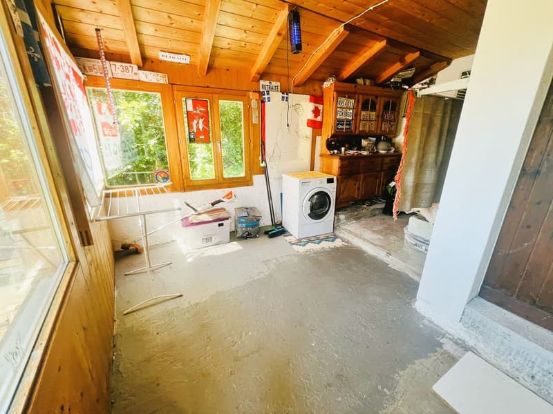 wooden walls, white washing machine, wooden floor, windows, wooden cabinet, storage boxes