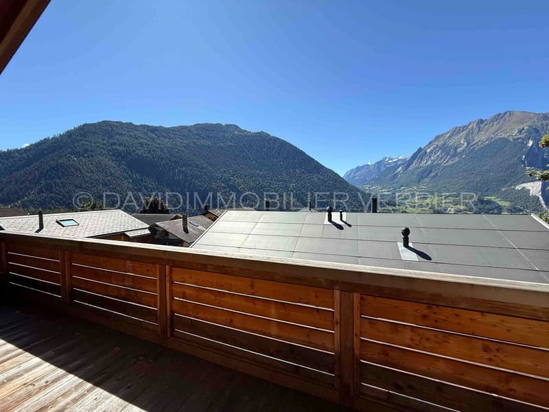 Wooden balcony overlooking a mountain valley
