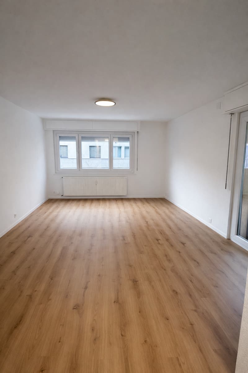 hardwood floor, radiator, recessed ceiling light, glass window, sliding glass door