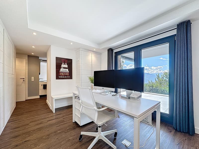 desk, white chair, two monitors, window with curtain, wooden floor