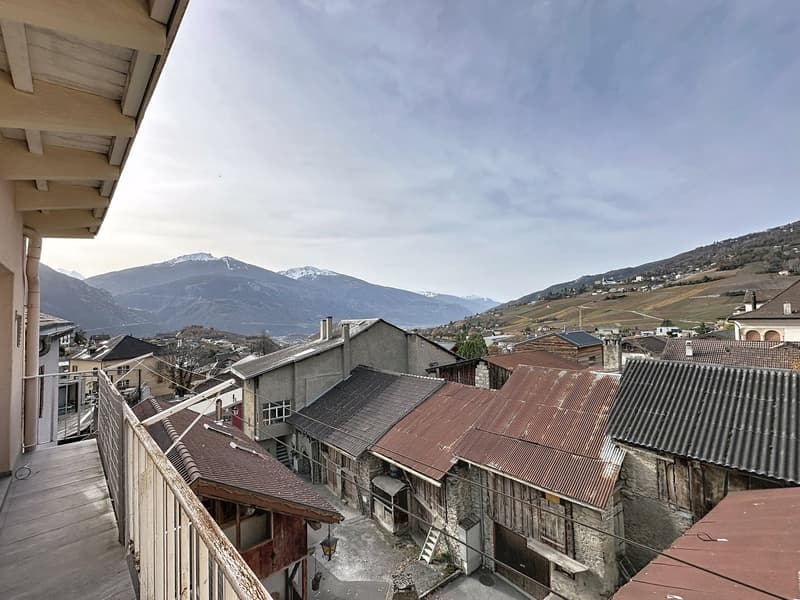 Balcony, mountains, buildings, clear sky