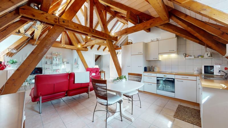 dining and living room, wooden beams, red couch, wooden dining table, modern kitchen