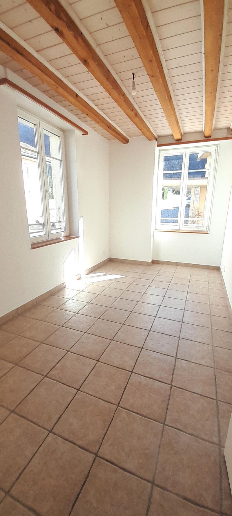 empty room, wooden ceiling, tiled floor, two windows