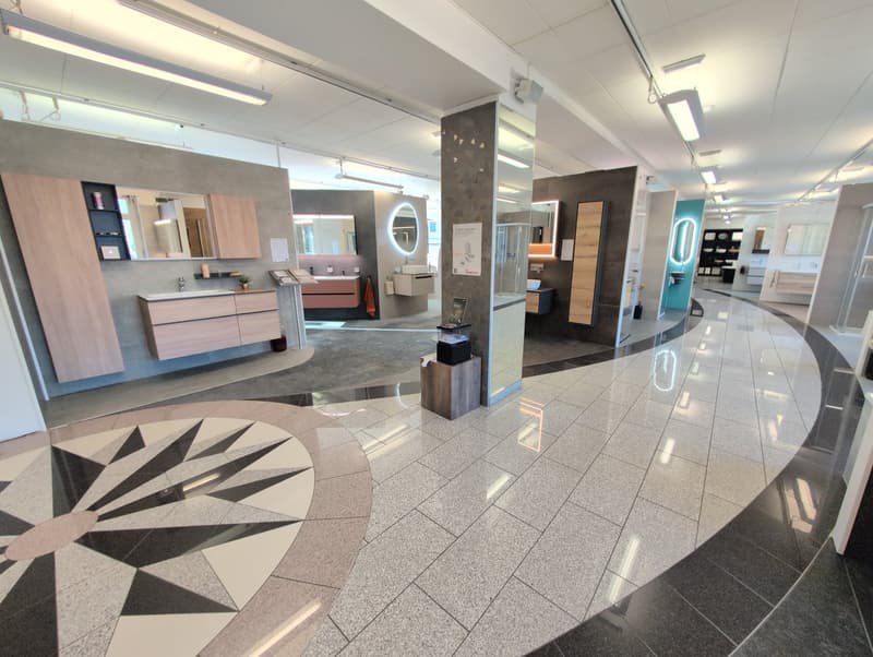 open interior with marble floors, modern furniture, lighting, mirrors, and various displays