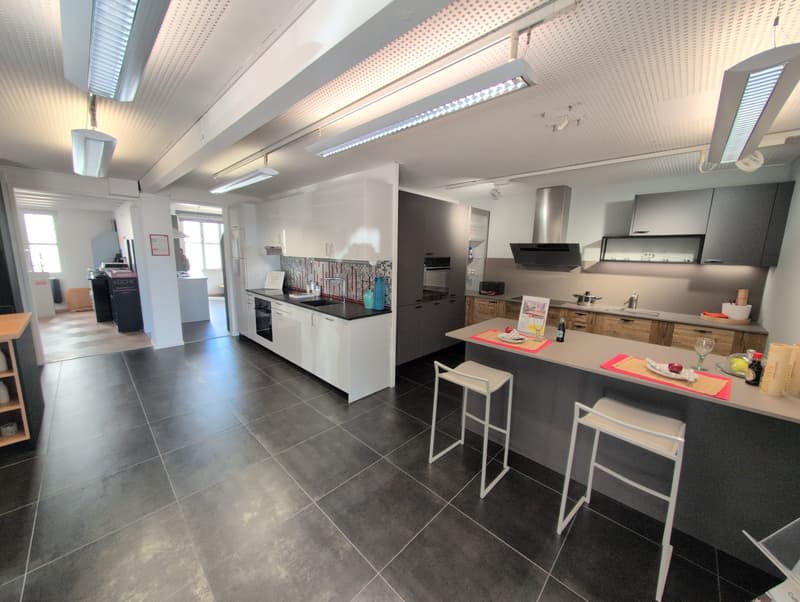 modern kitchen with white cabinets, granite countertops, integrated appliances, island, white tile flooring