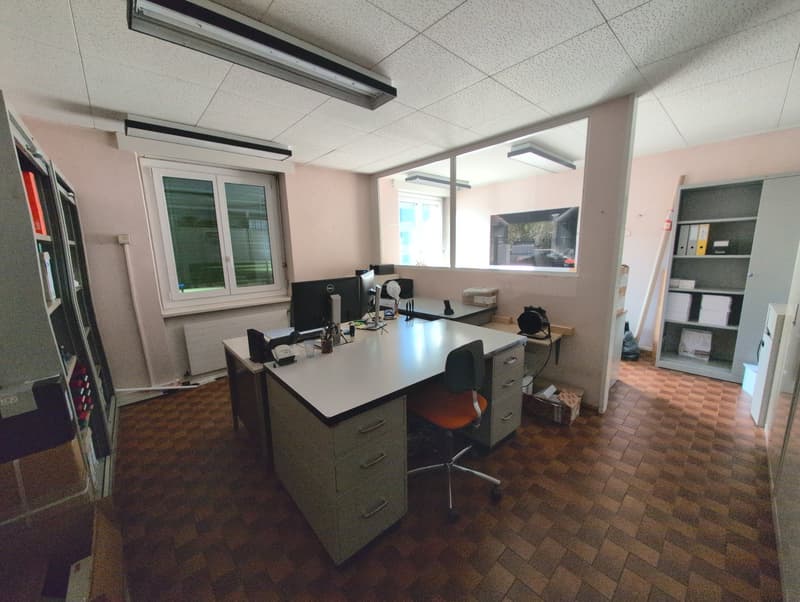 empty office with desks, chairs, cabinets, shelves, and lamps