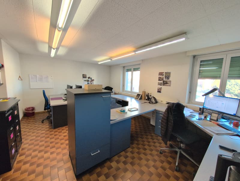 Office room, desks, chairs, computers, monitor, lamp, filing cabinets, trash bin, whiteboard