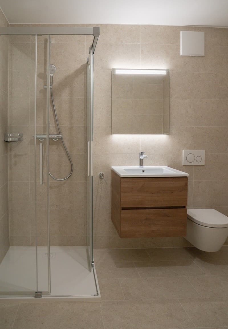 shower stall, bathtub, sink, mirror, toilet, wooden vanity, tiled flooring