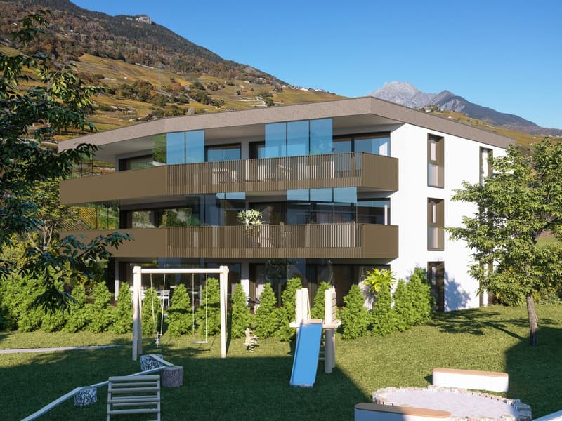 Modern apartment building, 3 floors, glass windows, brown balconies, surrounded by grass and trees, view of mountains