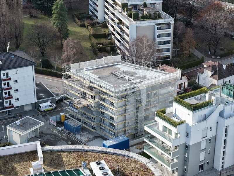 Under construction apartment building, green roofs, scaffolding
