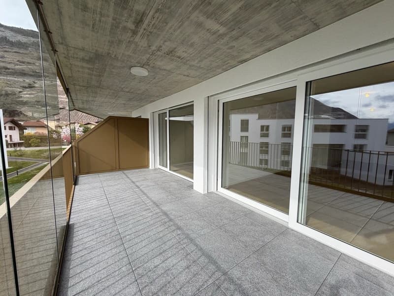 Balcony with glass railings, tiled floor, glass walls, ceiling light, view of the mountains