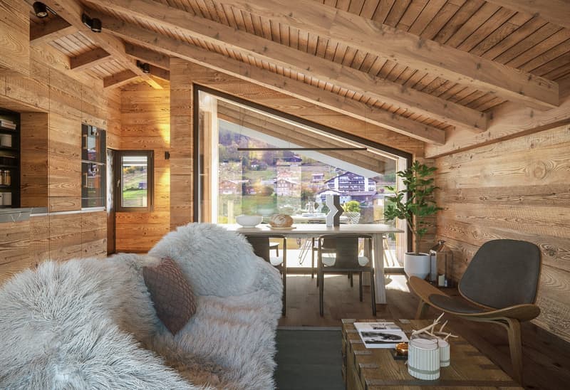 wooden walls and ceilings, window with mountain view, round table, sofa, armchair, coffee table