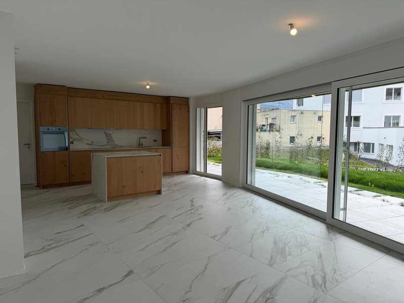 modern kitchen with marble flooring, wooden cabinets, large windows, island countertop, oven, sink, faucet, large sliding glass doors, outdoor view
