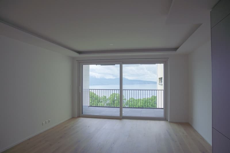 empty room, wooden floor, sliding glass doors, balcony, lake view