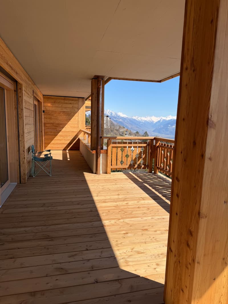 wooden floor, wooden walls, balcony, folding chair, mountain view