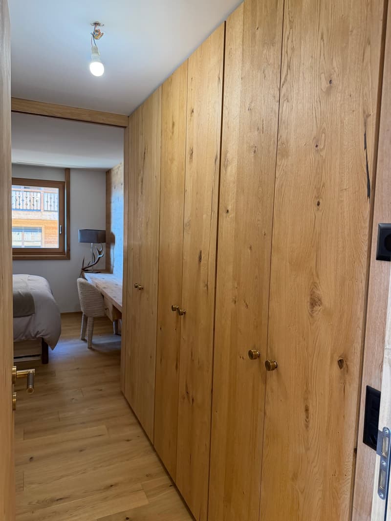 wooden wardrobe, wooden floor, bed, desk, lamp, window