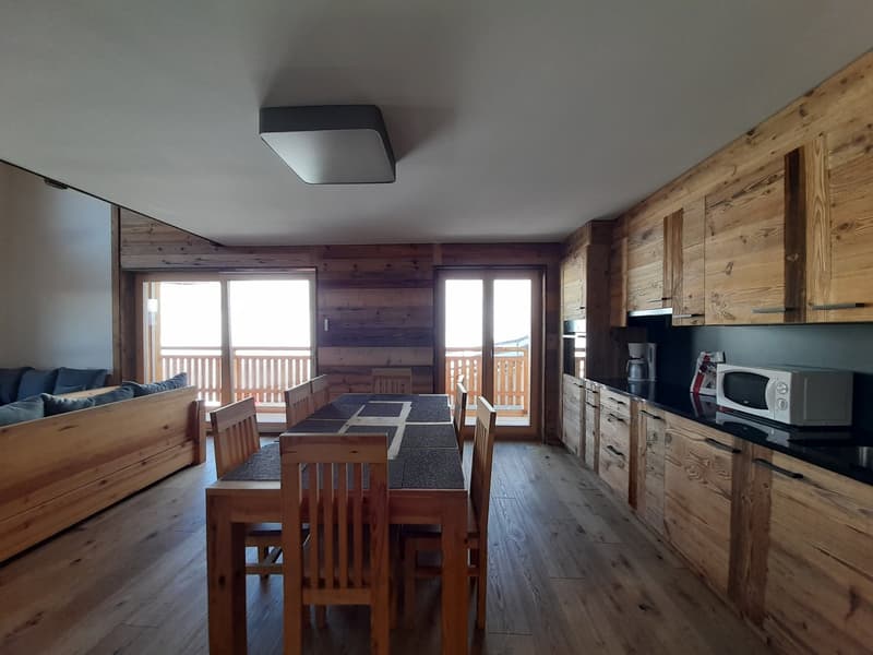 dining table, wooden chairs, wooden cabinets, microwave, coffee maker, wooden flooring