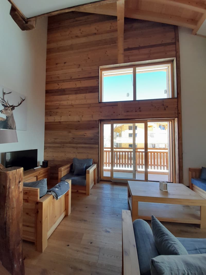 wooden walls, wooden furniture, balcony, large windows, TV, table, sofa