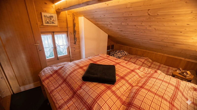 bedroom with wooden walls, two beds, window, wooden nightstand, picture frame