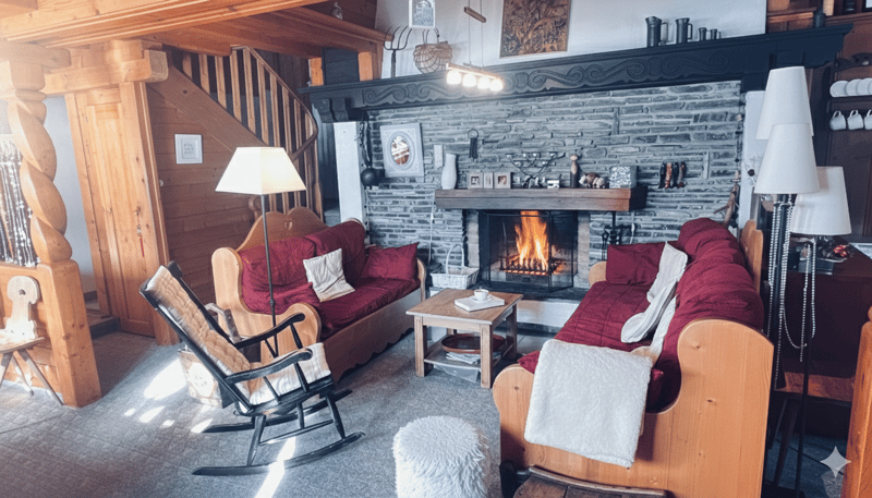 Carpeted floor, brick fireplace, wooden couch, rocking chair, coffee table, lamp, wooden stairs