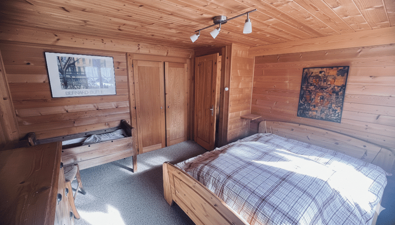wooden room, bed, wooden dresser, two closets, painting, window