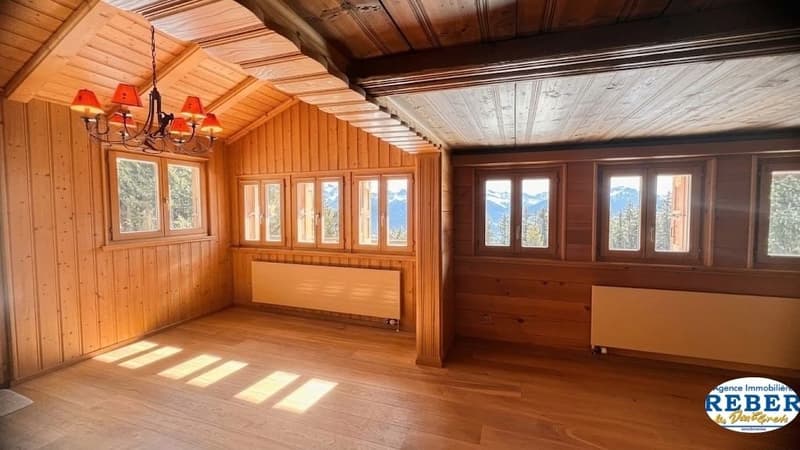 wooden walls, wooden floor, chandelier, radiators, windows with mountain view