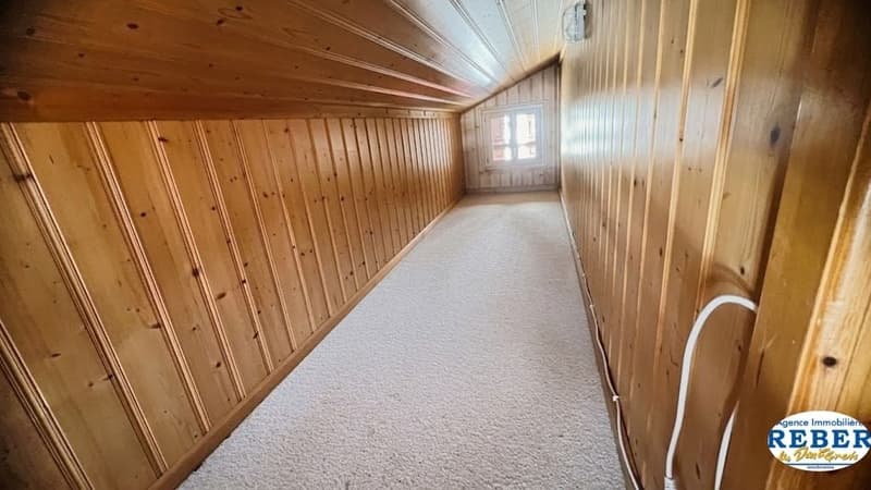 wooden walls, white carpet, small window