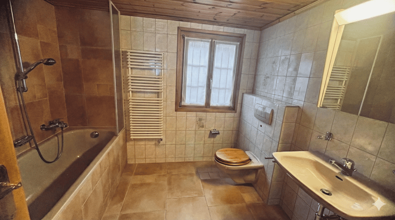 Bathroom with bathtub, toilet, sink, window, and towel rack