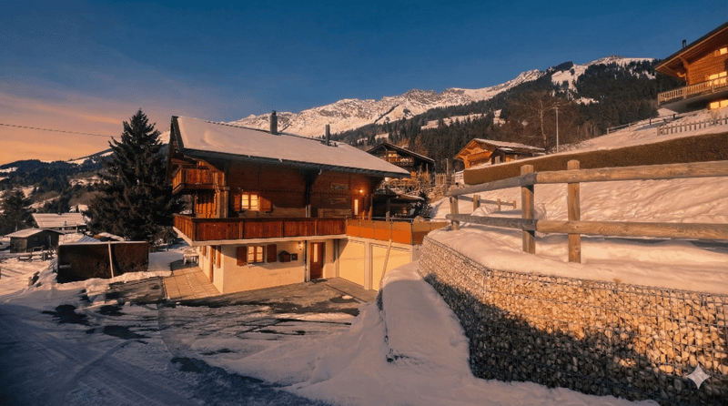 wooden chalet, snow covered roof, balcony, wooden fence, snowy mountain in the background