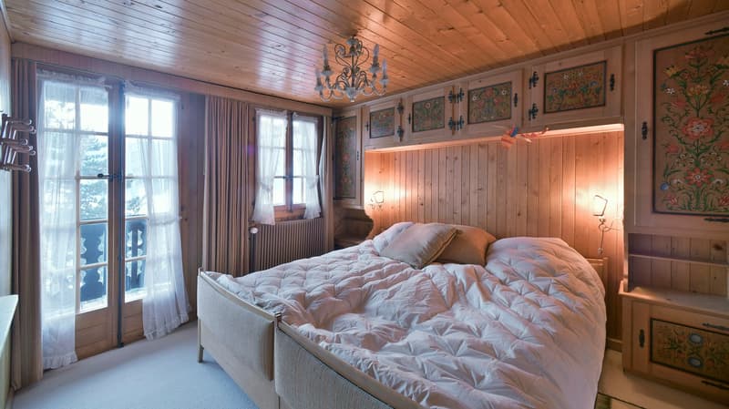 wooden interior, large bed, large windows, curtains, night lamps, bed pillows, chandelier, wooden shelves