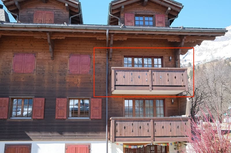 wooden exterior, red shutters, two balconies, mountain view