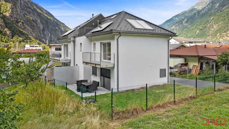 2 story house, white exterior, black tiled roof, solar panels, balconies, fenced yard, mountains in the background